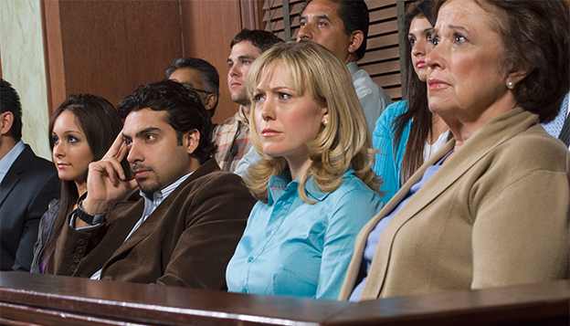 Panel of diverse jurors with varying facial expression that imply they are actively listening or engaged within a courtroom setting